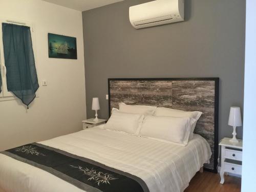 a bedroom with a large bed with white pillows at Modern Villa with Pool in Montauroux France in Montauroux