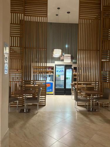a restaurant with tables and chairs in a room at Linhares Design Hotel LC in Linhares
