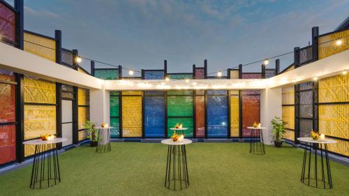 a room with tables and stained glass windows at Crowne Plaza Residences Port Moresby by IHG in Port Moresby