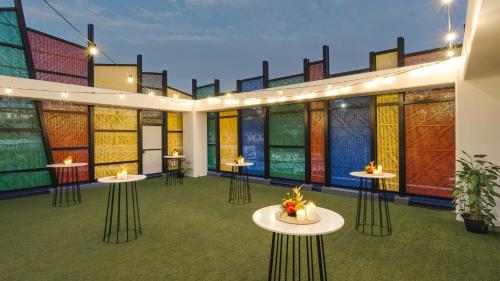 a room with tables and stained glass windows at Crowne Plaza Residences Port Moresby by IHG in Port Moresby