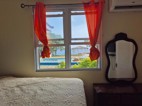 a bedroom with a window with a view of a pool at Maranatha villa in Discovery Bay