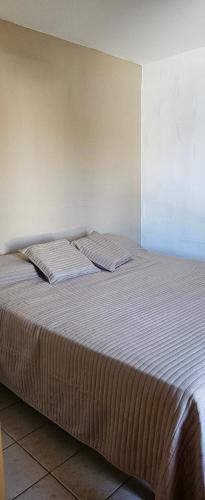 a bed with two pillows on it in a room at La NIÑA 6 in Jesús María
