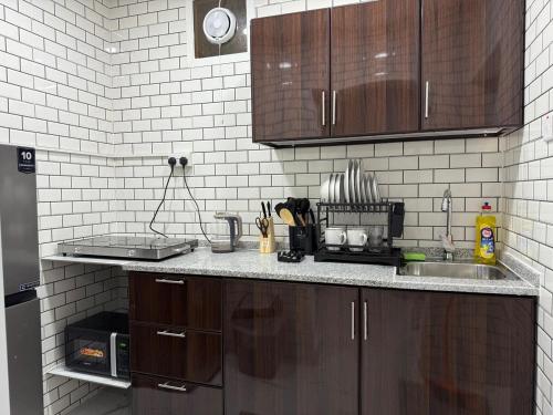 a kitchen with a sink and a counter top at Brand new -Stylish Studio Near to Yas & Airport in Abu Dhabi