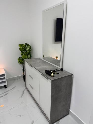 a dressing room with a mirror and a dresser at Brand new -Stylish Studio Near to Yas & Airport in Abu Dhabi