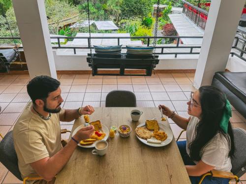 a man and woman sitting at a table eating food at Tierra Maravilla in Salento