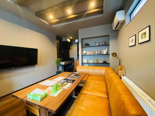 a living room with a couch and a table at Js STAY OTARU II in Otaru