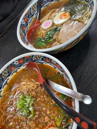 two bowls of soup on a table with a spoon at 一棟貸切,新築,広いドッグランの庭付き,ペット可,海徒歩10分,bbq,美味しい肉セット注文可 in Jōnouchi