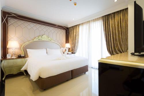 Кровать или кровати в номере LK Pattaya