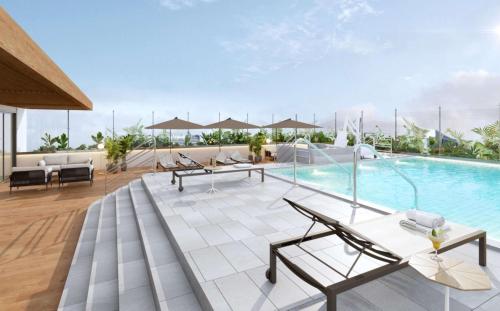 an outdoor patio with a pool and tables and chairs at Hampton By Hilton Santiago De Los Caballeros Monument in Santiago de los Caballeros