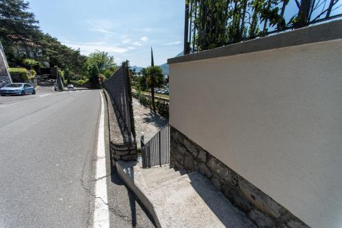 a fence on the side of a road at Residenza Decimina in Varenna