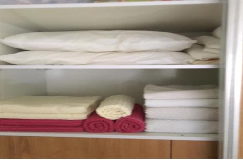 a closet filled with towels and a pile of towels at Luxury Sea View Apartment in Herzelia 