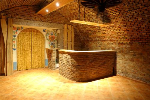 an empty room with a brick wall and a counter at Penzion u Tomčalů in Terezín