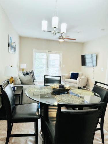 a living room with a table and chairs at Great Location Heart of Addison in N Dallas! in Addison