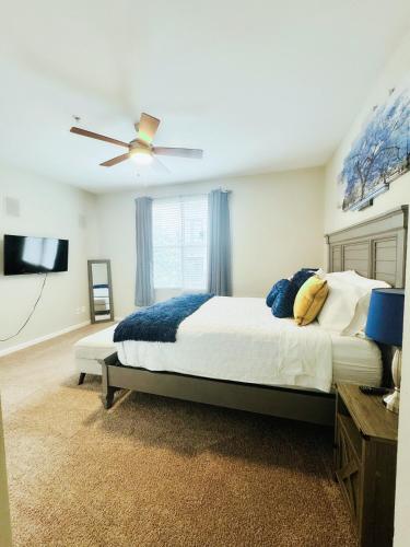 a bedroom with a bed and a ceiling fan at Great Location Heart of Addison in N Dallas! in Addison