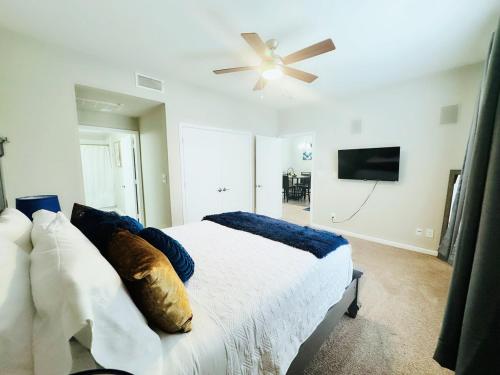 a bedroom with a bed and a ceiling fan at Great Location Heart of Addison in N Dallas! in Addison