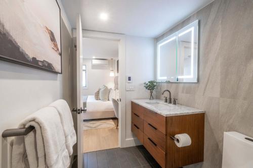 a bathroom with a sink and a toilet and a window at New Listing Renovated 2 BR Aspen Condo in Aspen