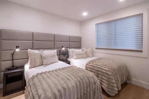 a bedroom with two beds and a window at New Listing Renovated 2 BR Aspen Condo in Aspen