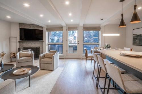 a living room with a table and chairs and a fireplace at New Listing Renovated 2 BR Aspen Condo in Aspen