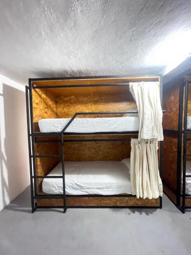 two bunk beds sitting in a room with a wall at The Boat House Cancun in Cancún