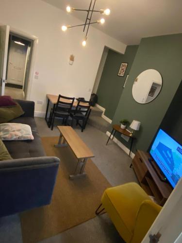 a living room with a couch and a table at Warrington Guest House in Stoke on Trent