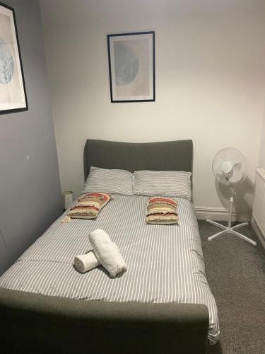 a bed in a bedroom with two towels on it at Warrington Guest House in Stoke on Trent