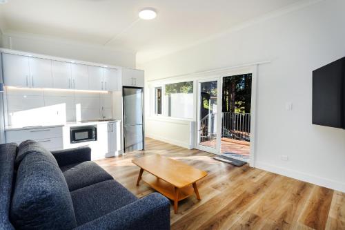 a living room with a couch and a table at Hunters Moon in Mosgiel