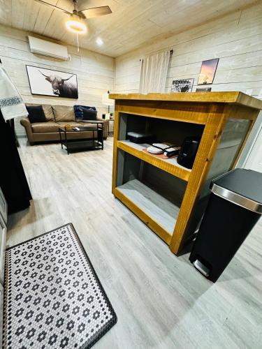 a living room with a couch and a fireplace at High Noon Hideout Tiny Home in Springtown TX in Springtown