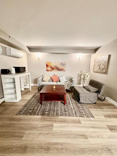 a living room with a couch and a table at Private walkout basement apt in Lower Sackville