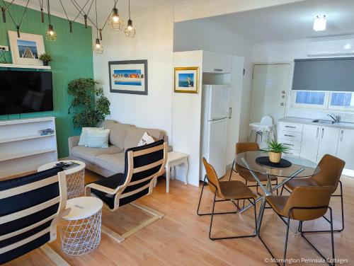 a living room with a couch and a table and chairs at MP Beach Club in Tootgarook