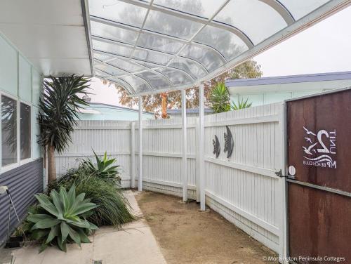 a greenhouse on the side of a house with plants at MP Beach Club in Tootgarook