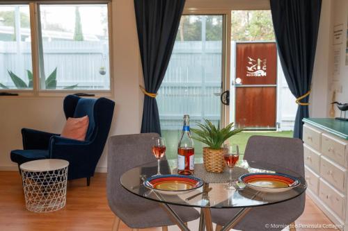 a dining room with a glass table and chairs at MP Beach Club in Tootgarook