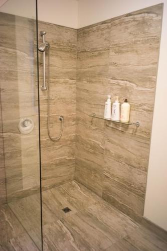 a bathroom with a shower with two soap bottles at MP Beach Club in Tootgarook