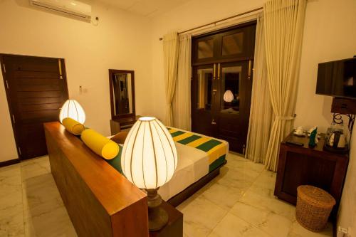 a living room with a couch and two lamps at Huluganga Ridge, Kandy in Kandy