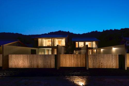 a house with a fence at night at Villa NIGIN in Miyazu