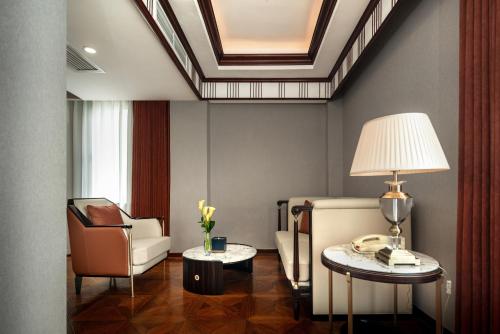 a living room with a couch a chair and a table at Shanghai Park Hotel - Hudec Excellent Historical Building - Priority Access for Classic Butterfly Cookies Without queuing to guests in Shanghai