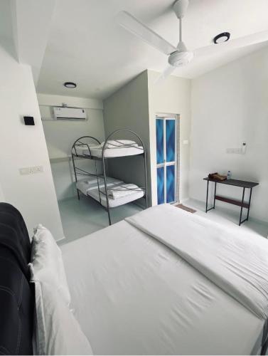 a white bed in a room with a bunk bed at CasaView Beach in Paka