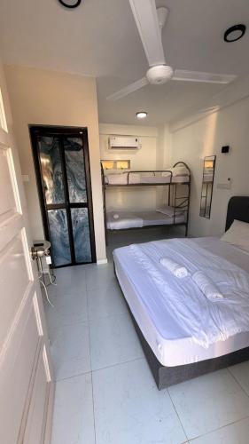 a bedroom with a bed and two bunk beds in it at CasaView Beach in Paka