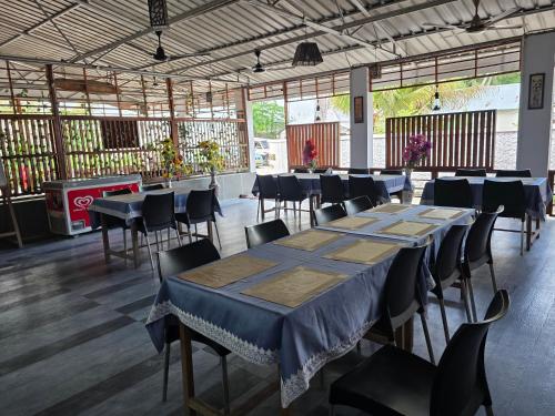 a room with a long table and chairs at Lemon Grass Resort & Spa in Havelock Island