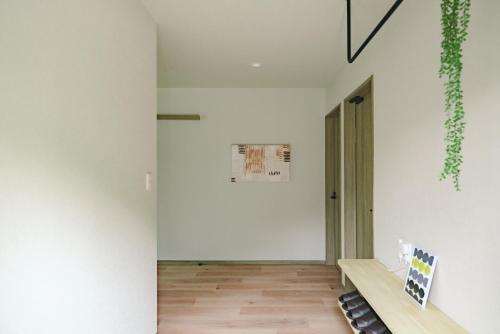a hallway with white walls and a wooden floor at Green Peak 1 in Aso