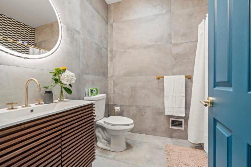 a bathroom with a toilet and a sink and a mirror at Historic Old City 1BR 1BA Near Independence Hall in Philadelphia