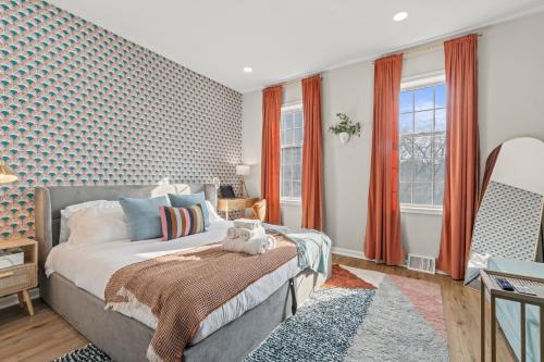 a bedroom with a bed and orange curtains at Historic Old City 1BR 1BA Near Independence Hall in Philadelphia