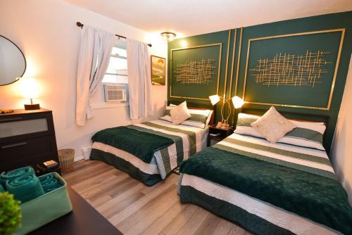 a bedroom with two beds and a desk and a window at Bool Bear Lodge a pet friendly Pocono Vacation Home in Tobyhanna