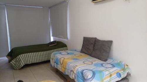 a small bedroom with a bed and a couch at Las Piedras in Pilar