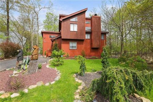 a house with a garden in front of it at Bool Bear Lodge a pet friendly Pocono Vacation Home in Tobyhanna