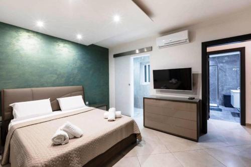 a bedroom with a bed and a flat screen tv at Luxury Apartment in Gzira close to Sliema 3 BR Apartment Sleep 8 in Il-Gżira