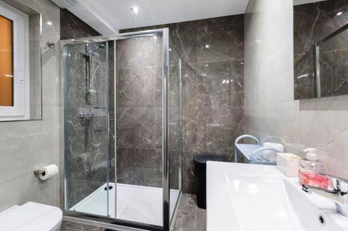 a bathroom with a shower and a toilet and a sink at Luxury Apartment in Gzira close to Sliema 3 BR Apartment Sleep 8 in Il-Gżira