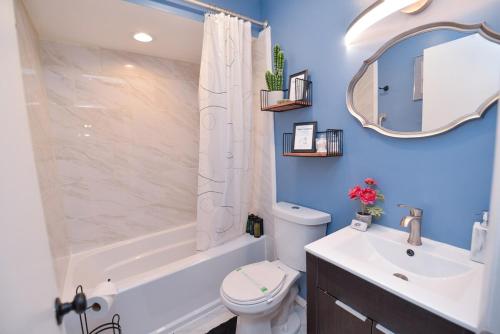 a bathroom with a white toilet and a sink and a mirror at Bool Bear Lodge a pet friendly Pocono Vacation Home in Tobyhanna