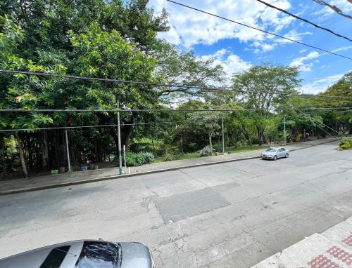 a car parked on the side of a street at CASA FAMILAR frente al parque in Buga
