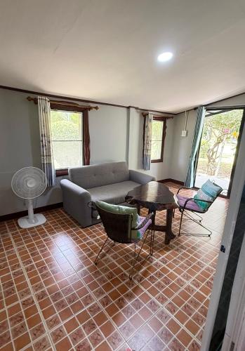 a living room with a couch and a table at Wandee Resort Bankrut in Ban Krut