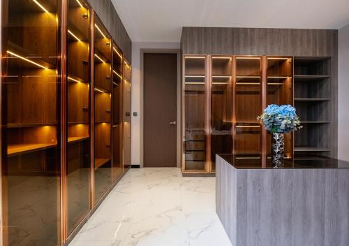 a dressing room with a vase of flowers on a counter at Sirintara pool villa in San Sai
